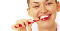 Woman brushing teeth with Invisalign clear braces