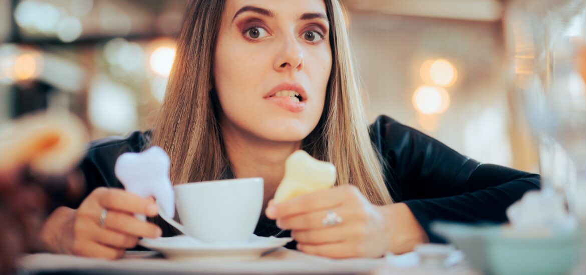 worried woman with yellow teeth in coffee shop